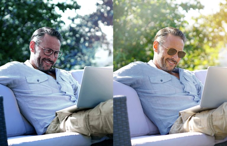 Mann mit Sonnenbrille sitzt entspannt mit Laptop auf einer Couch im Freien.